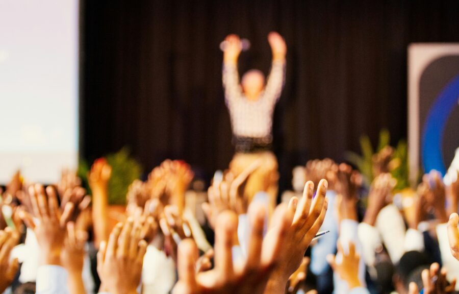 Conference Speakers Motivating Large Crowd With Their Hands In The Air Demonstrating Benefits Of A Good Call For Papers